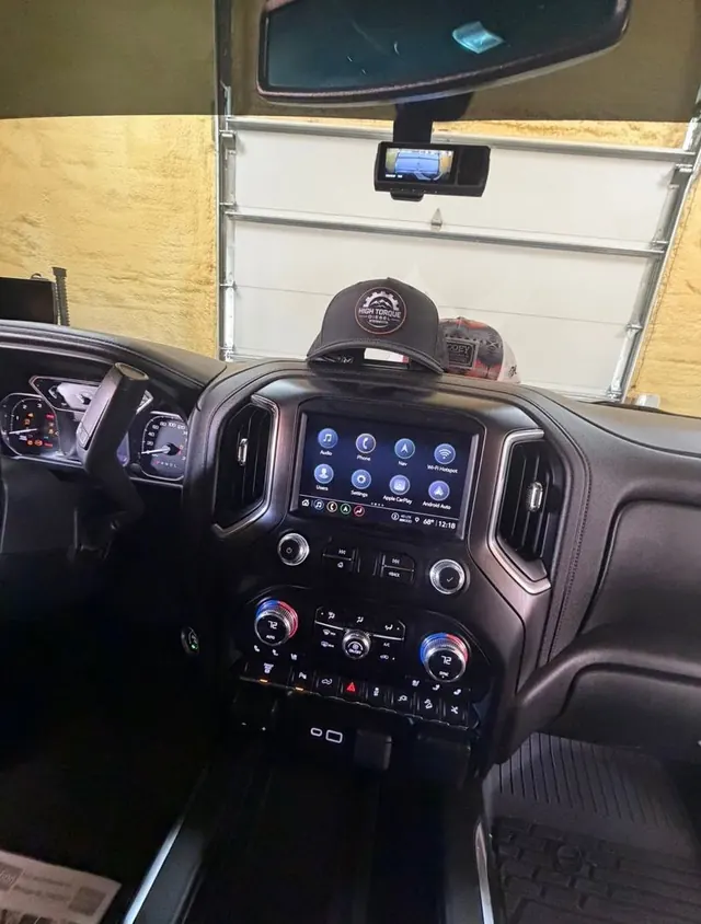 A truck interior with a High Torque Diesel cap on the dash