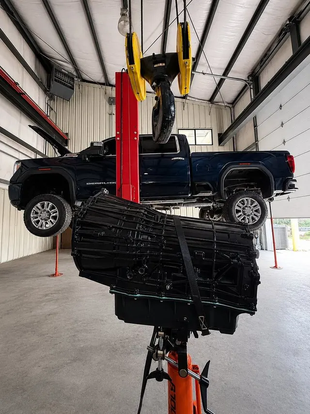 A heavy-duty pickup on the lift with the transmission removed