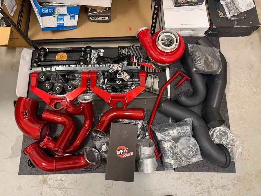 A set of performance parts laid out before installation